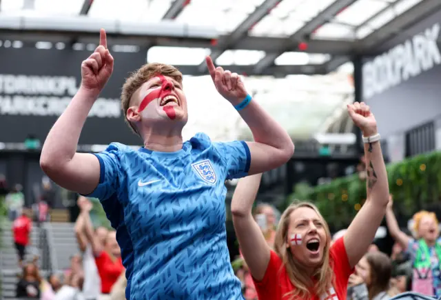 England fans in Boxpark cheer as they see Stanway's penalty scored.