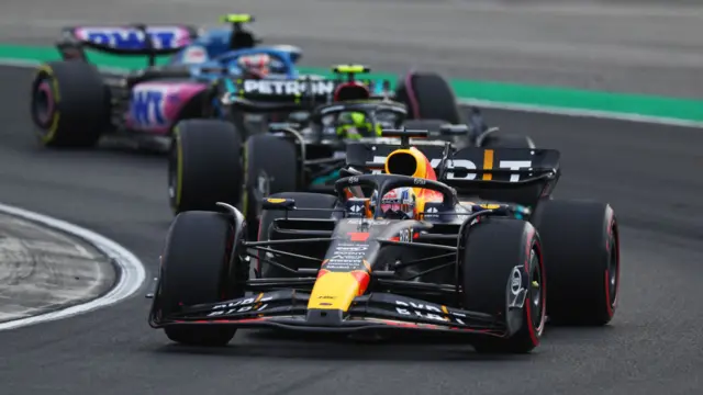 Max Verstappen and Lewis Hamilton race with F1 cars