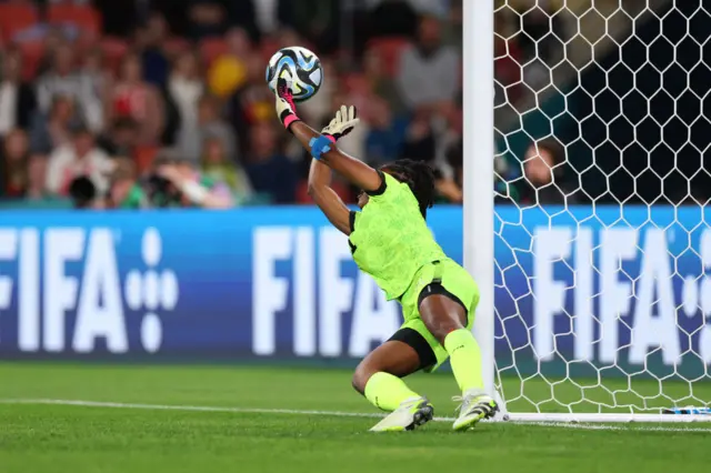 Kerly Theus saves from Georgia Stanway's penalty kick.