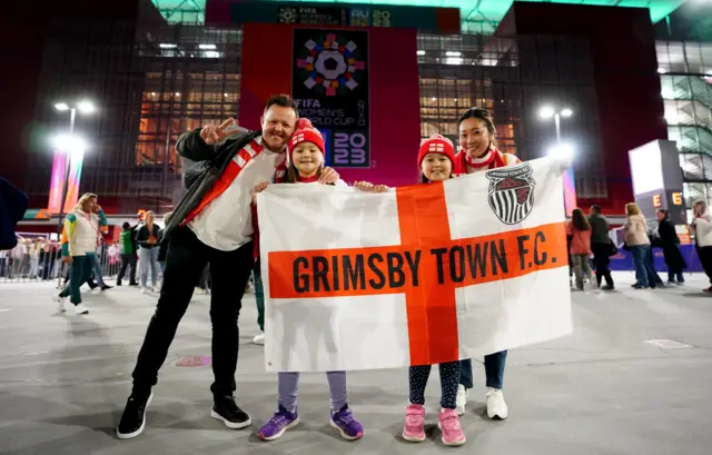 Grimsby-based Lionesses fans hold up a banner outside the stadium.