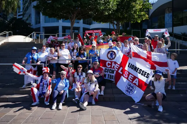 England fans pose with flags ahead of making their way to the match.