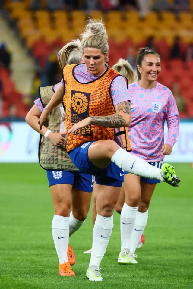 England captain Millie Bright leads the warm up.