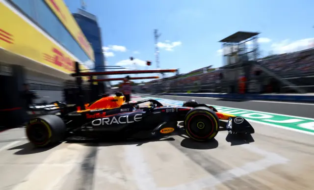 Max Verstappen drives his Reb Bull car out of his pit box