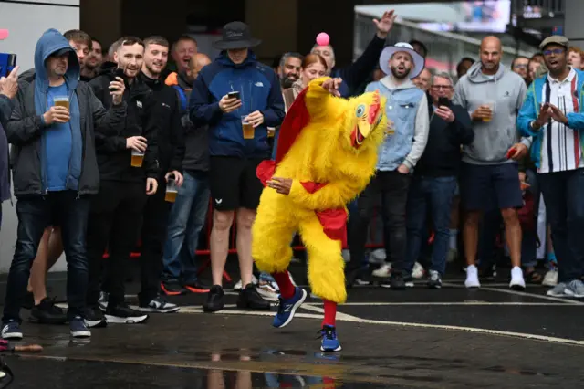 Man dressed as chicken bowling
