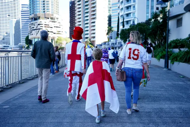 England fans make their way through Brisbane towards the stadium.