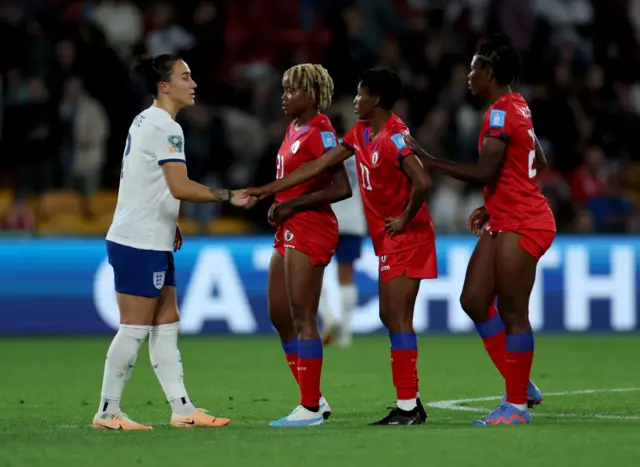 Lucy Bronze congratulates her opponents from Haiti.