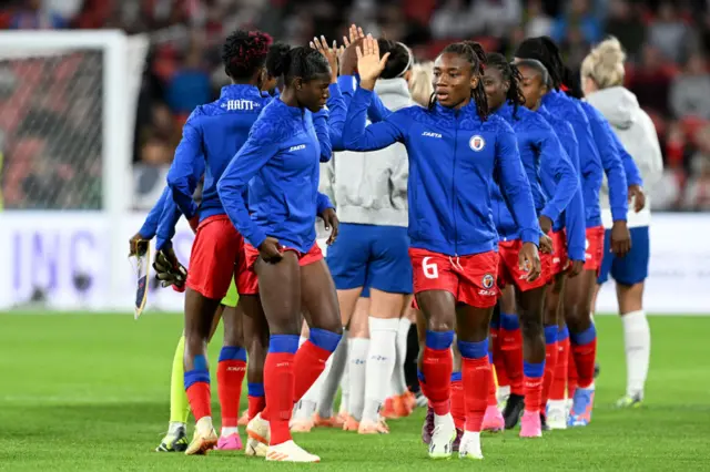 England and Haiti players shake hands before kick off.