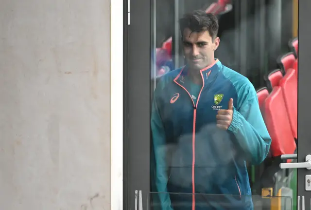 Pat Cummins gives a thumbs up gesture to someone at Old Trafford