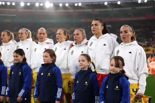 Sweden players sing the national anthem ahead of kick off.