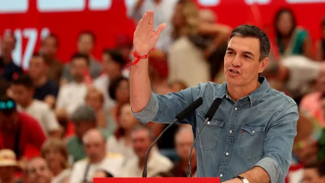 Pedro Sanchez speaks from a lectern