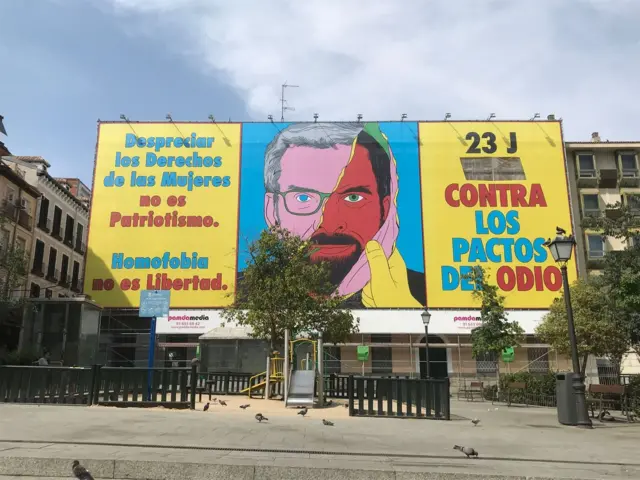 A billboard in Madrid shows a mask of Alberto Nunez Feijoo, the leader of the PP, being removed to reveal Vox leader Santiago Abascal underneath.