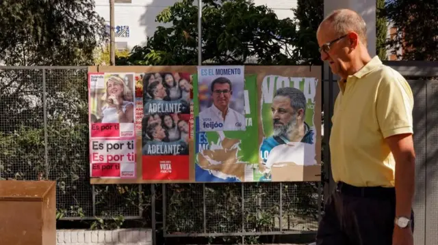 A man walks past electoral posters of Spain's left-wing Sumar leader Yolanda Diaz, Spain's acting Prime Minister and Socialist leader Pedro Sanchez, Spanish opposition Popular Party leader Alberto Nunez Feijoo and Spain's far-right Vox party leader Santiago Abascal, ahead of the July 23 snap election, in Ronda, Spain July 7, 2023