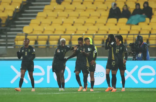 South Africa players congratulate Magaia after she scored the opening goal.