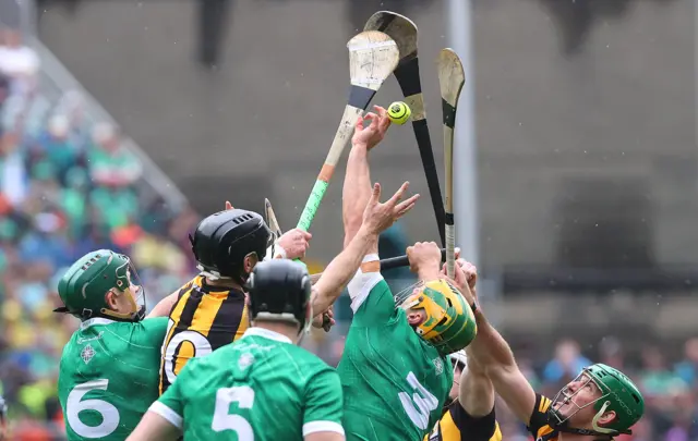 Kilkenny and Limerick players fight for possession.