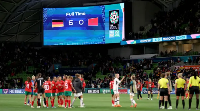 A screen displays the full time score after Germany beat Morocco 6-0