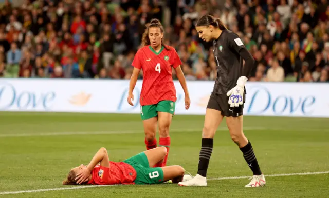 Elodie Nakkach of Morocco holds her head and lies on the floor