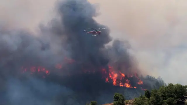 A helicopter helps to fight fires