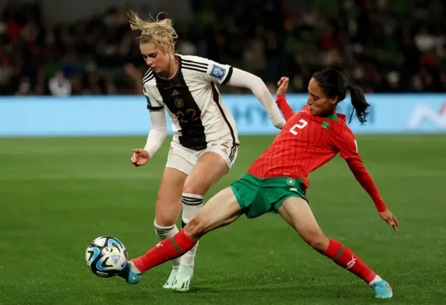 Morocco's Zineb Redouani tackles Germany's Jule Brand