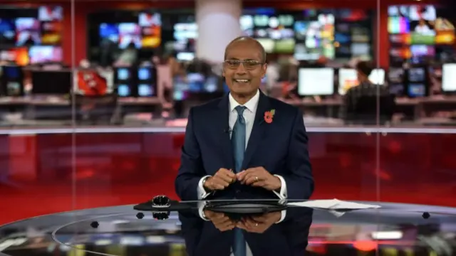 Alagiah smiles at the newsdesk