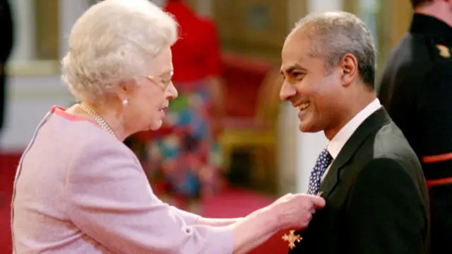 The late Queen Elizabeth II presents Alagiah with his OBE award in 2008