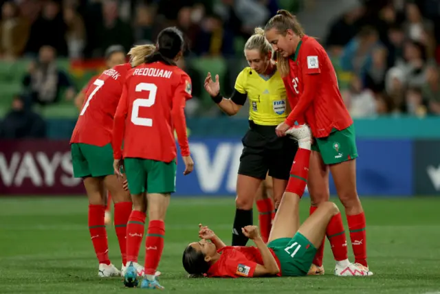 Hanane Ait El Haj gets her leg stretched out by a team-mate