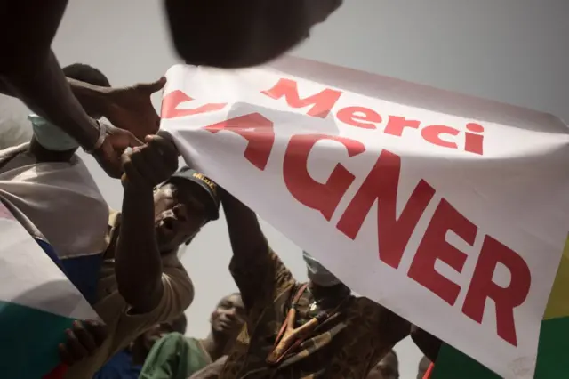 Protesters holds a banner reading "Thank you Wagner", the name of the Russian private security firm present in Mali, during a demonstration organised by the pan-Africanst platform Yerewolo to celebrate France's announcement to withdraw French troops from Mali, in Bamako, on February 19, 2022.