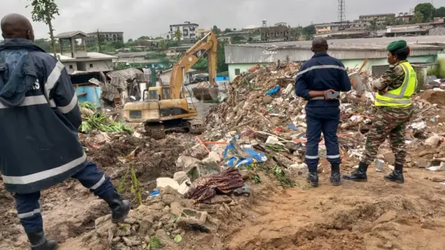 Emergency services look at the site of the collapse.