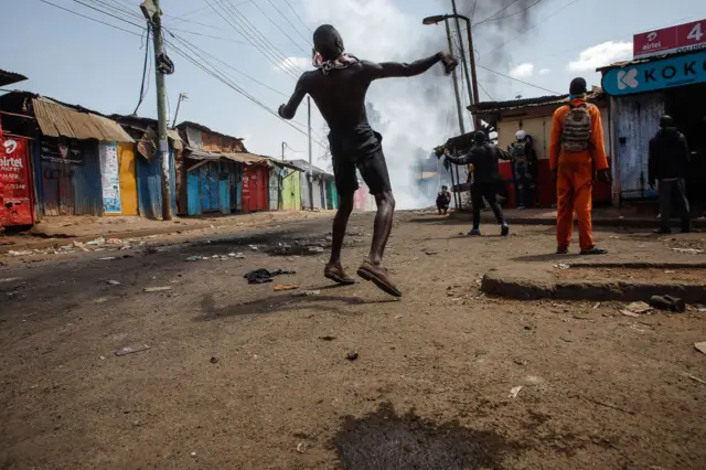 A protester throwing stones back to the riot police during the Azimio la Umoja-One Kenya protest over high living cost on July 21, 2023 in Nairobi, Kenya.