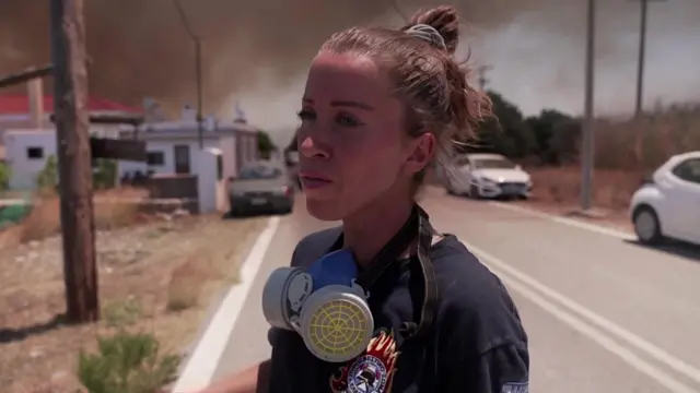 Maria Pardalou wearing firefighter uniform and a facemask around her neck