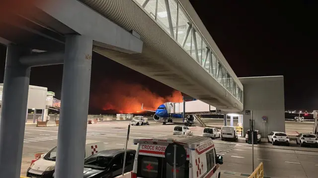 A wildfire burns near the Sicilian airport in Palermo