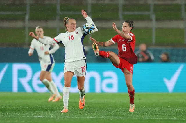 Frida Maanum of Norway and Geraldine Reuteler of Switzerland compete for the ball