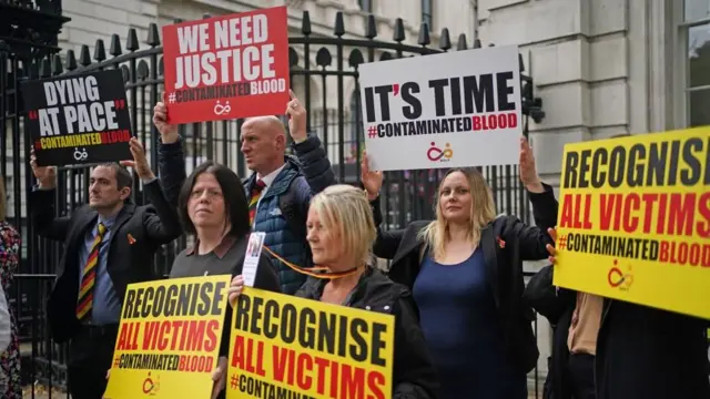 Demonstrators, demanding the government "recognise all victims", protest outside No 10