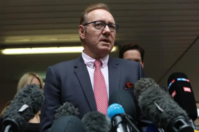 Kevin Spacey speaks with the media outside Southwark Crown Court