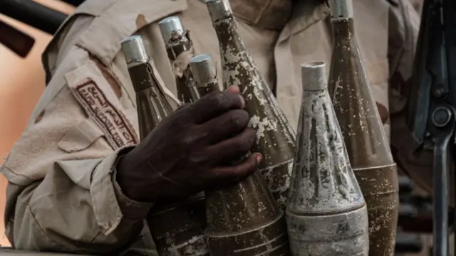 A member of Sudan's Rapid Support Forces (RSF) paramilitaries clutches rocket-propelled grenades - archive shot 2019