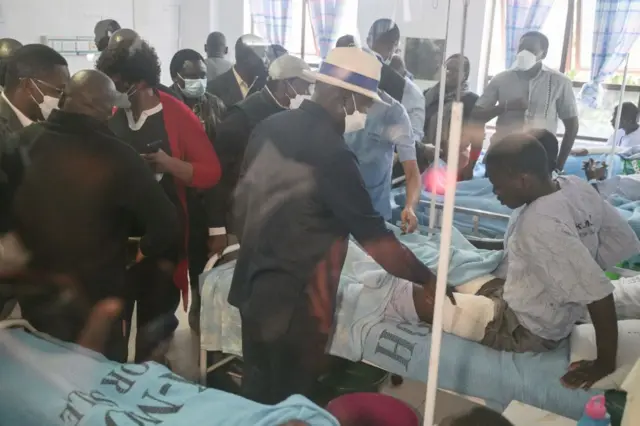 Kenyan opposition leader Raila Odinga (C) meets a protester that was injured in recent anti-government protests at the Mama Lucy Kibaki Hospital in Nairobi, on July 26, 2023.