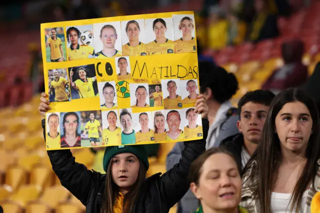 A young fan holds up a home made Matildas sign.