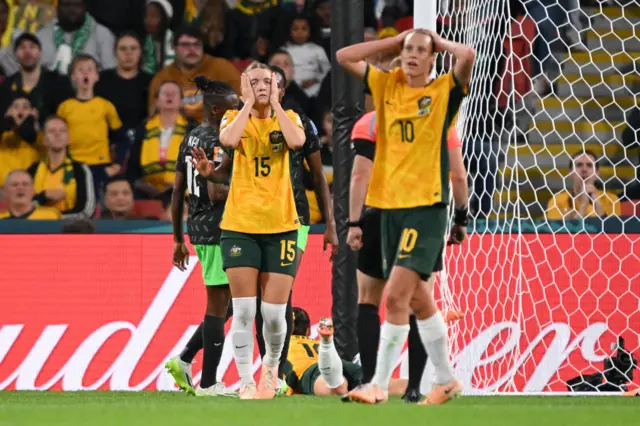 Australia players hold their heads in their hands after another missed chance.