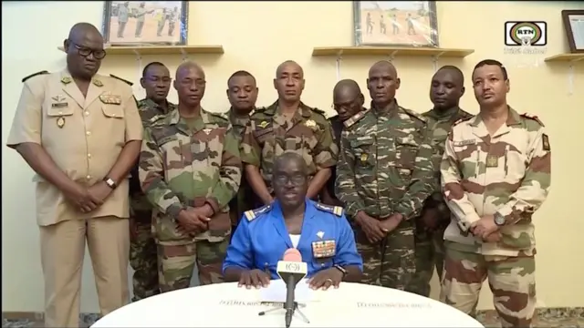 iger Army spokesman Colonel Major Amadou Adramane speaks during an appearance on national television, after President Mohamed Bazoum was held in the presidential palace, in Niamey, Niger, July 26, 2023 in this still image taken from video.