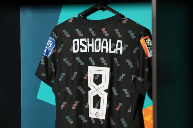 Oshoala's shirt hangs in the dressing room before kick off.