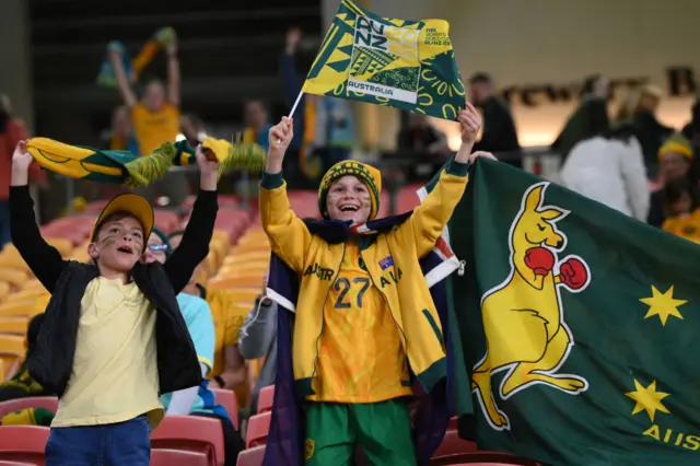 Australia fans wave flags in support of their side.