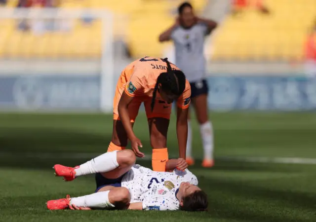 Emily Fox of USA goes down with an injury while Esmee Brugts of Netherlands talks to her