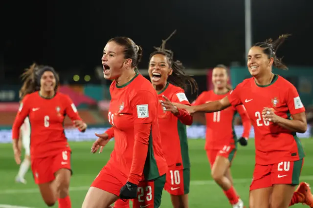 Telma Encarnacao celebrates with team-mates after scoring Portugal's opening goal.