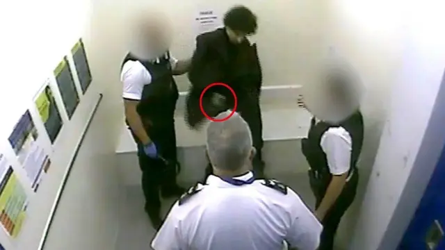 A screengrab from security camera footage shows Louis De Zoysa wielding a revolver despite being handcuffed