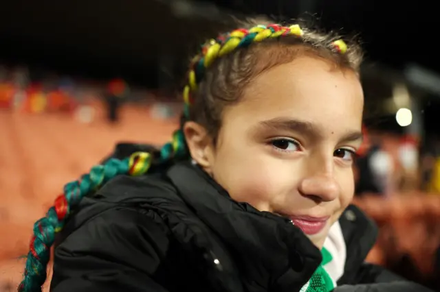 A young Portugal fan smiles at the camera ahead of kick off.