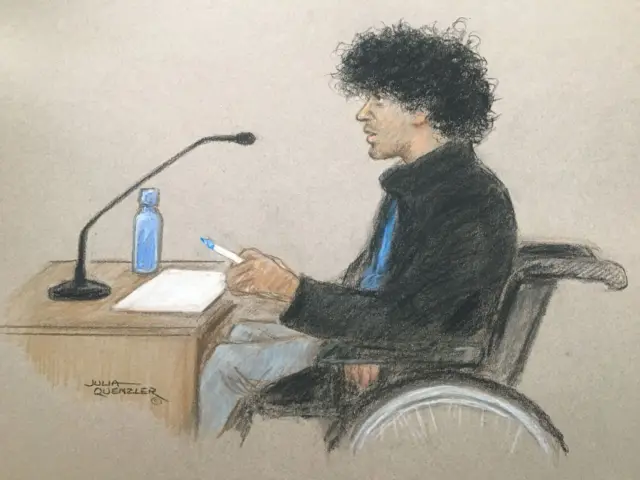 A court drawing depicts Louis De Zoysa in a wheelchair, using a whiteboard to communicate