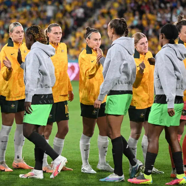 The players from both side shake hands after the anthems.