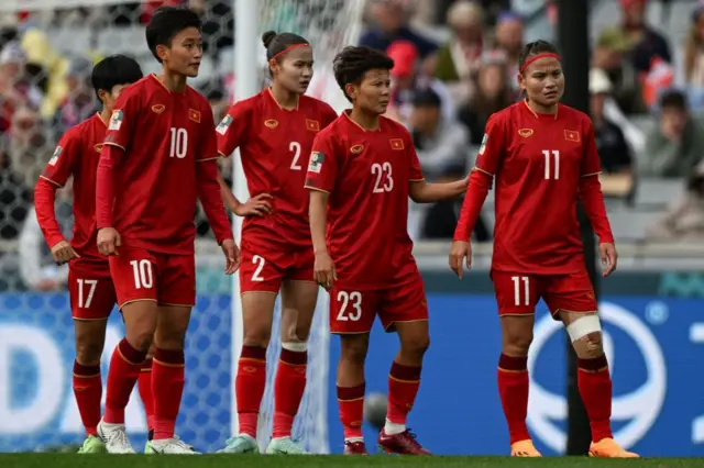 Vietnam players stand shellshocked after conceding against USA.