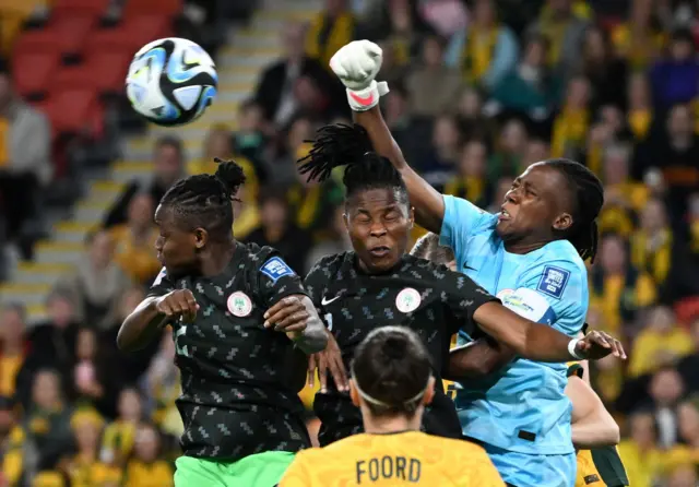 The Nigeria keeper punches clear a dangerous cross.