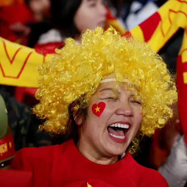 A Vietnam fan smiles with delight ahead of the Portugal game.