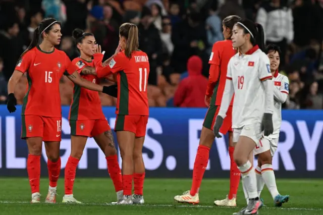 Portugal players congratulate each other at full time.